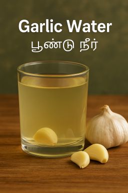 Glass of garlic water with raw garlic cloves beside it