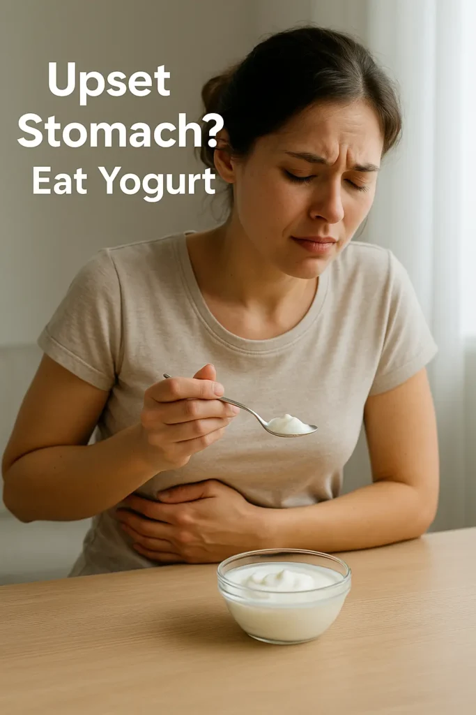 Bowl of plain probiotic yogurt on soft beige cloth with fresh mint and spoon beside it, overlaid with “Upset Stomach? Eat Yogurt”